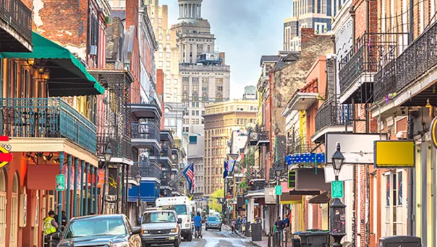 Historic urban street with balconies and vehicles