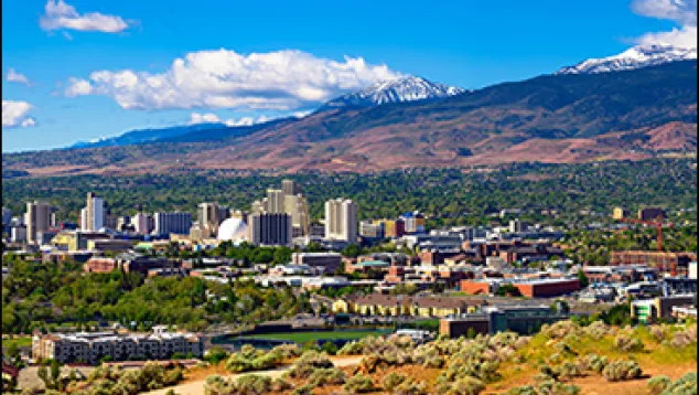 Cityscape with mountains and clear blue sky background